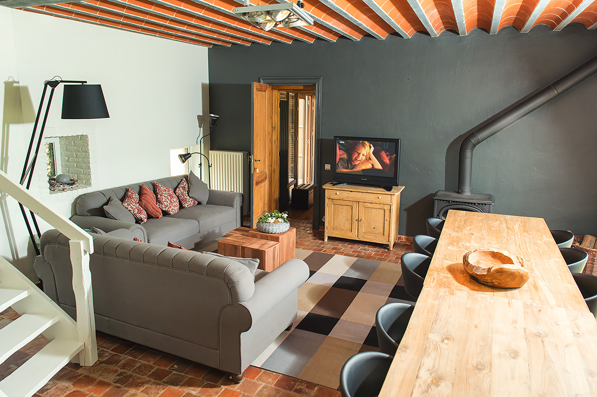 cozy sitting area with wood stove in our holiday home in the flemish ardennes